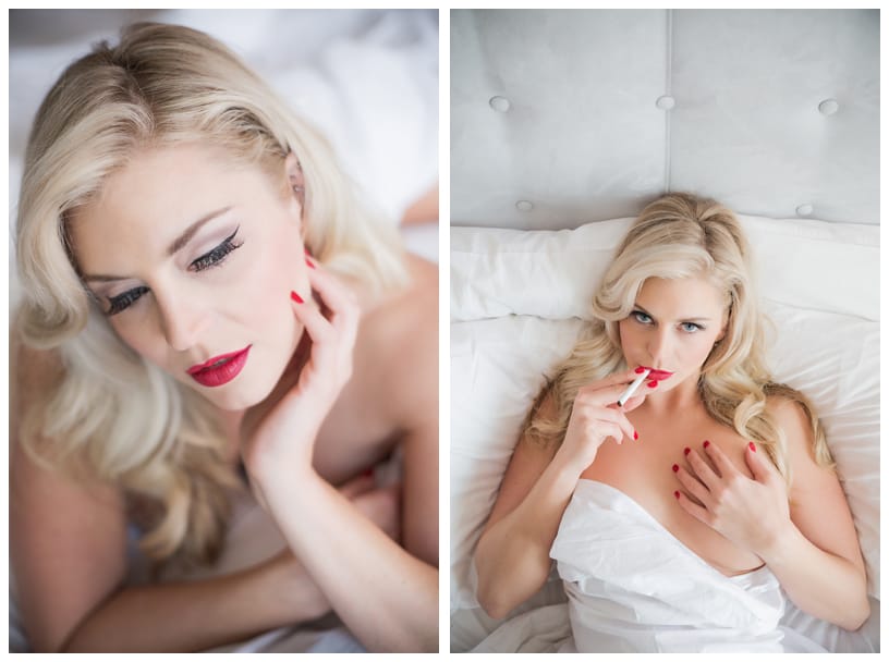 Woman relaxing on white bedding with cigarette